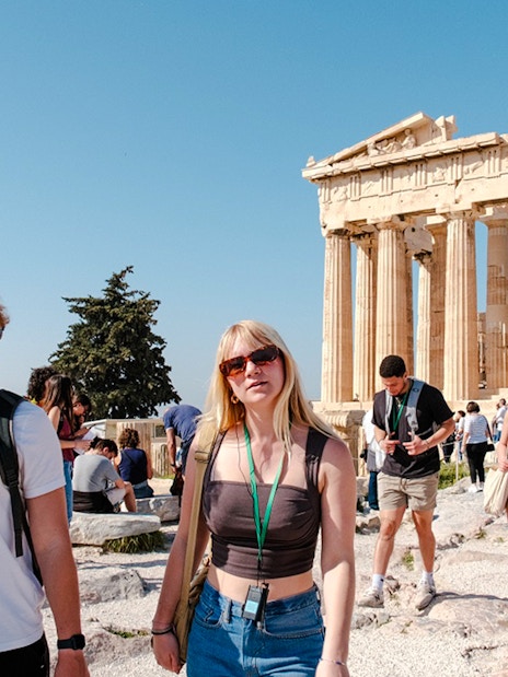 Guided tour group exploring the Parthenon in Athens, Greece.