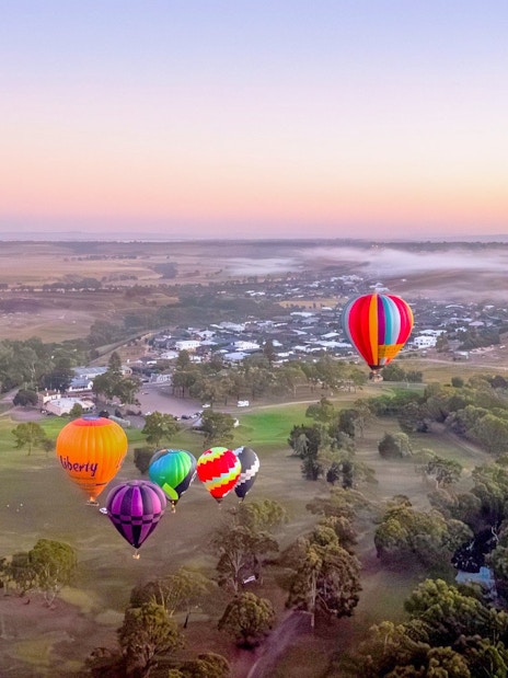 Hot air balloons over Geelong and Bellarine landscape at sunset, Liberty Balloon Flights, Australia.