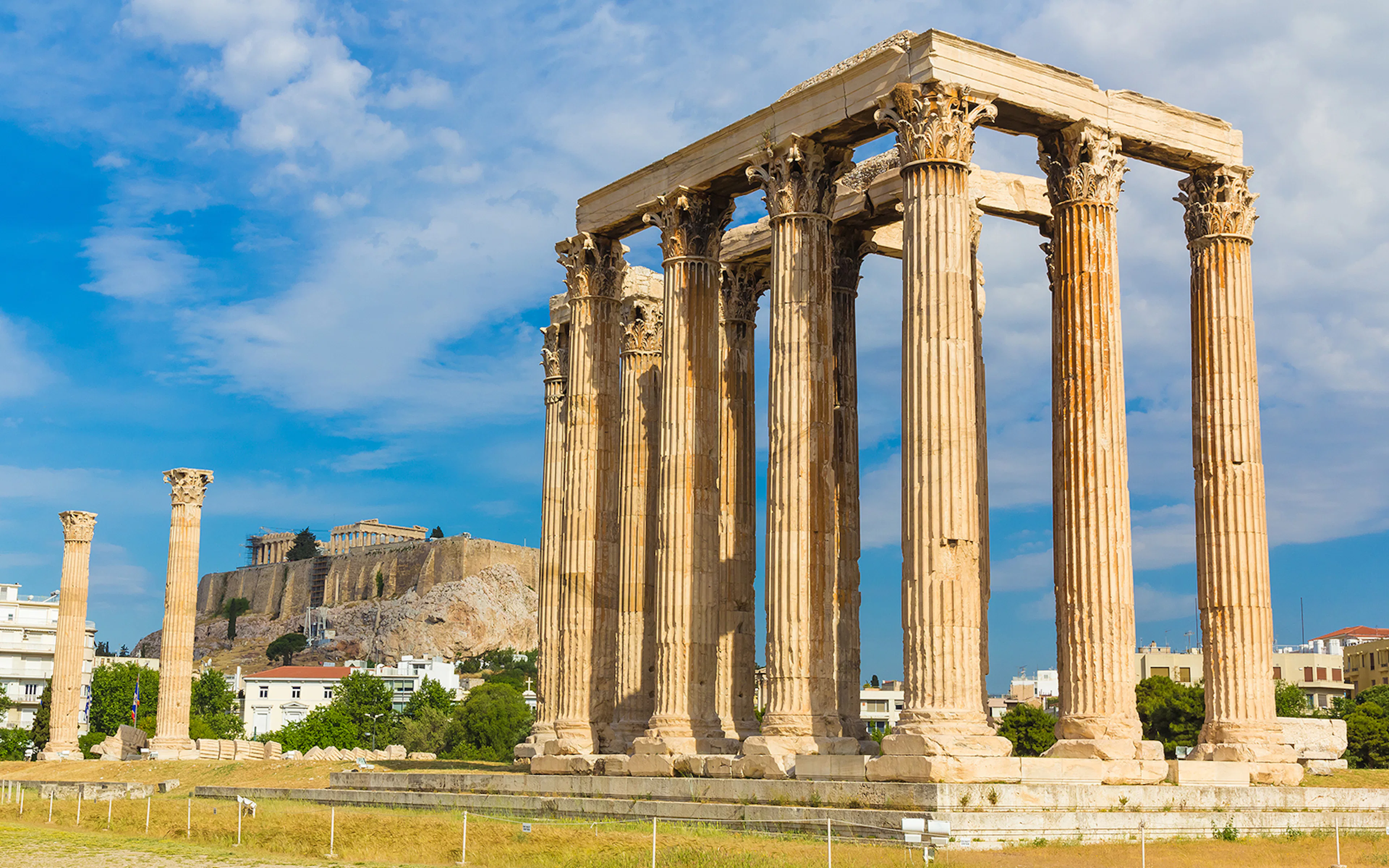 Ancient Temple of Zeus with Acropolis in background, Athens Hop on Hop off Tour.