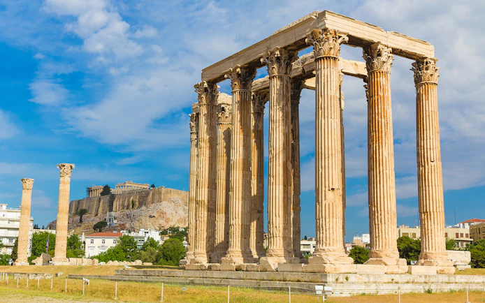 Ancient Temple of Zeus with Acropolis in background, Athens Hop on Hop off Tour.