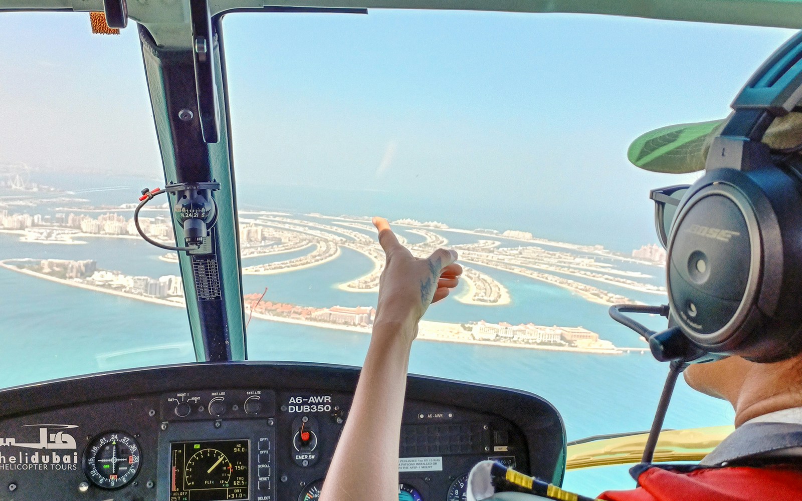 Helicopter pilot flying over Palm Jumeirah, Dubai