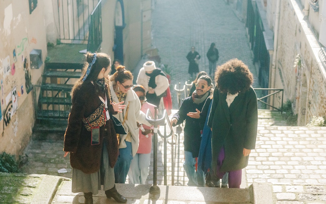 Group walking up Montmartre steps during Emily in Paris tour.