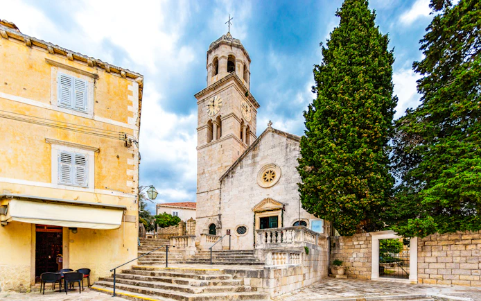Church of Saint Nicholas with clock tower and stone steps in Cavtat, Croatia.