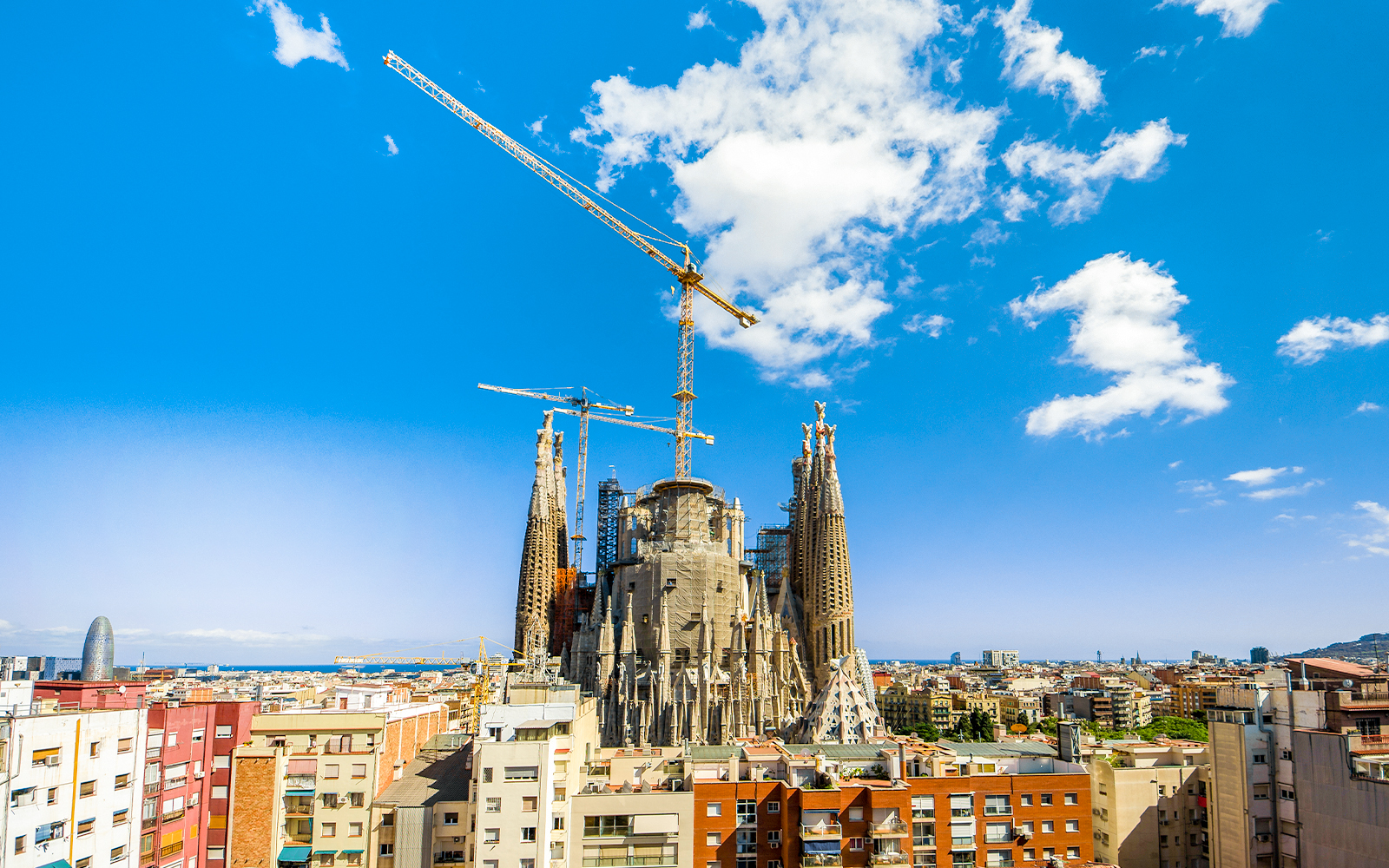 Sagrada Familia under construction with cranes in Barcelona, Spain.