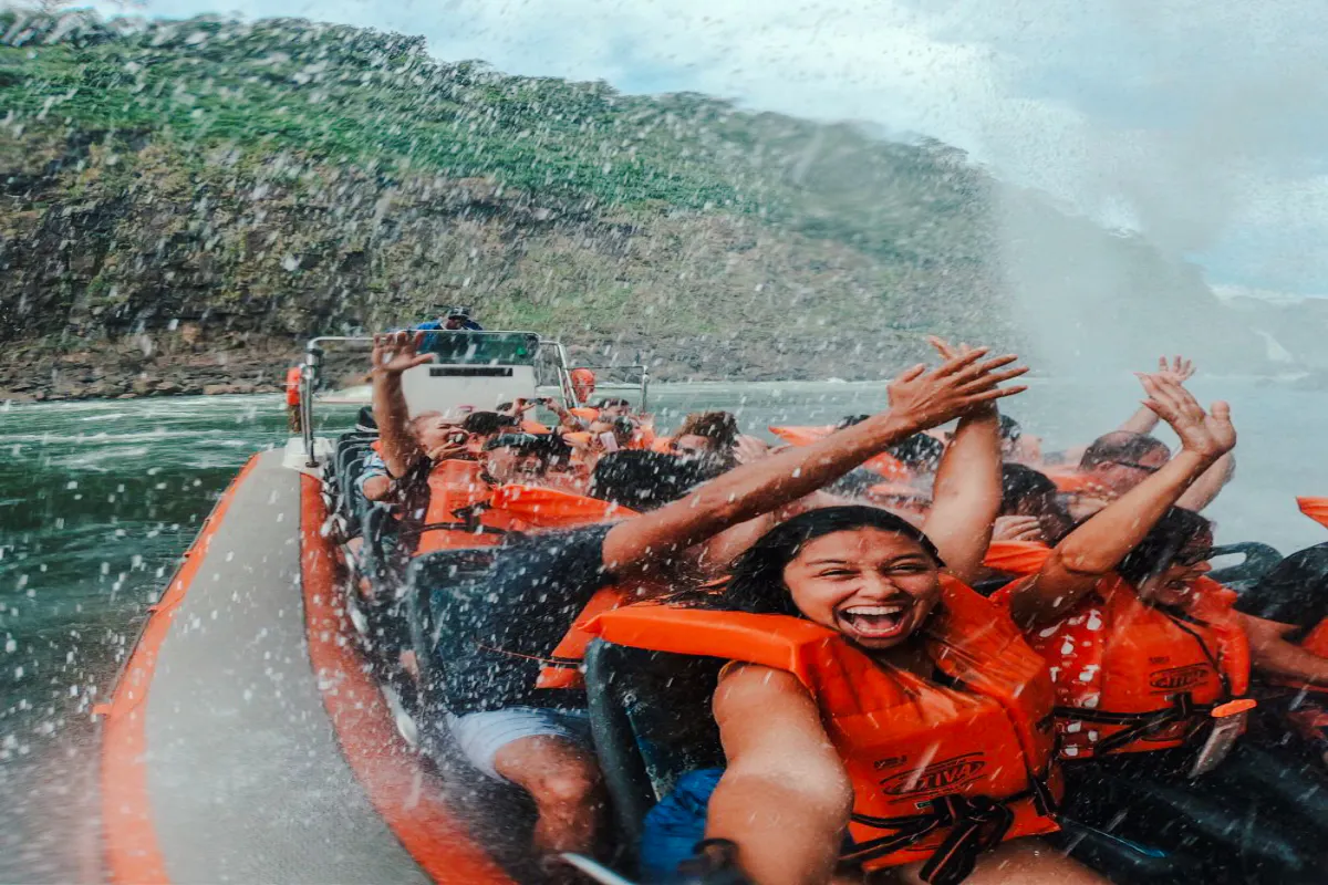 Tourists on a boat enjoying the Macuco Safari at Iguazu Falls, Foz do Iguacu.