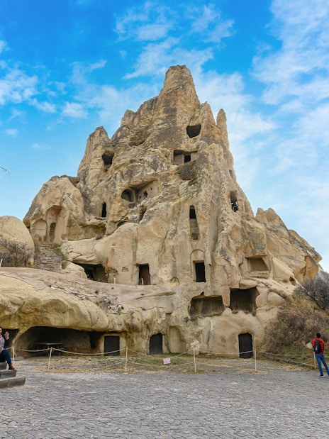Rock-cut churches at Goreme Open Air Museum, Cappadocia, with visitors exploring the site.