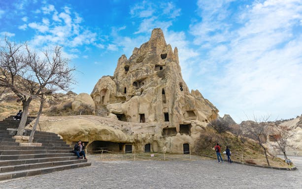 Rock-cut churches at Goreme Open Air Museum, Cappadocia, with visitors exploring the site.