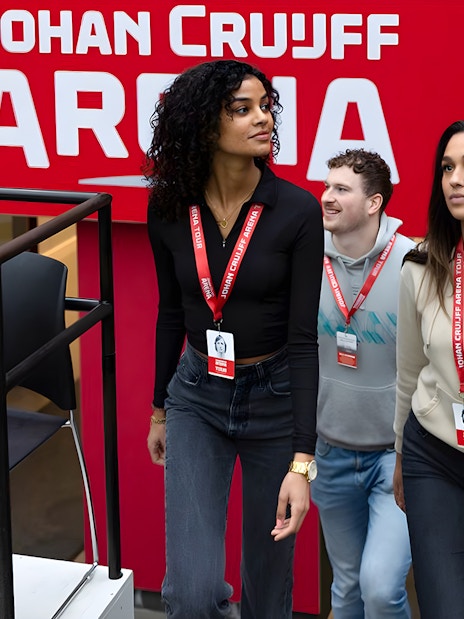 Visitors on Johan Cruijff ArenA Classic Tour with stadium backdrop.