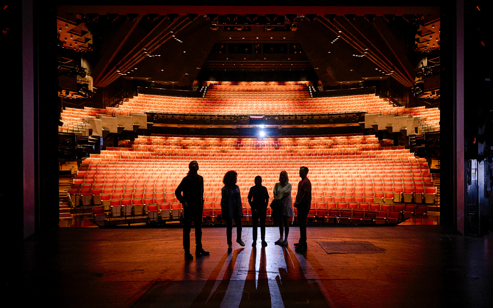 Backstage tour group at Sydney Opera House facing the auditorium.