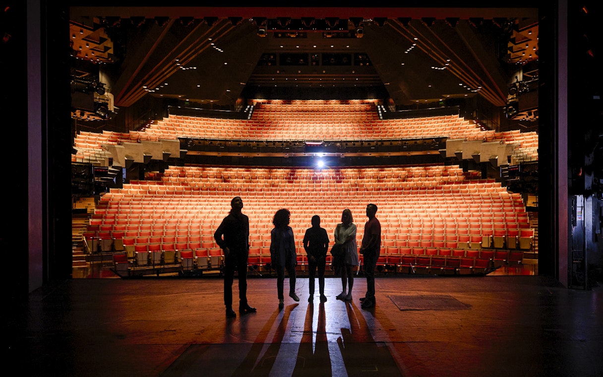 Backstage tour group at Sydney Opera House facing the auditorium.