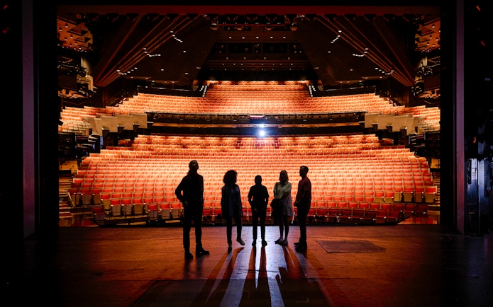 Backstage tour group at Sydney Opera House facing the auditorium.
