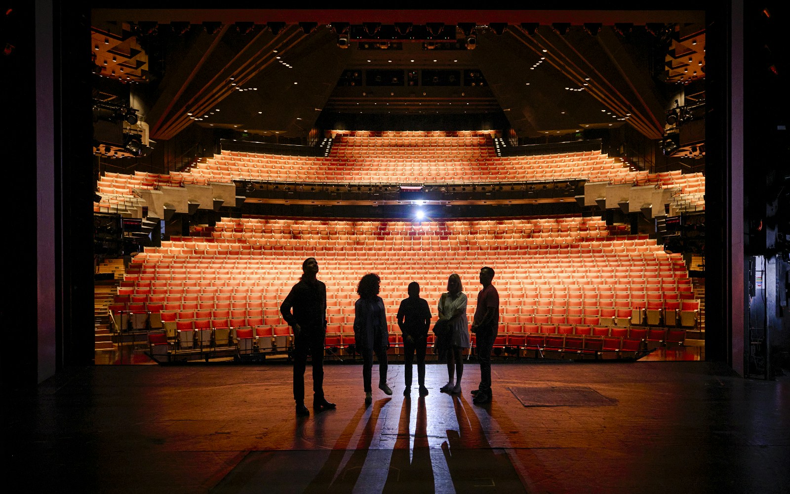 Backstage tour group at Sydney Opera House facing the auditorium.