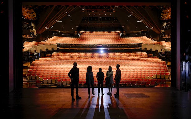 Backstage tour group at Sydney Opera House facing the auditorium.