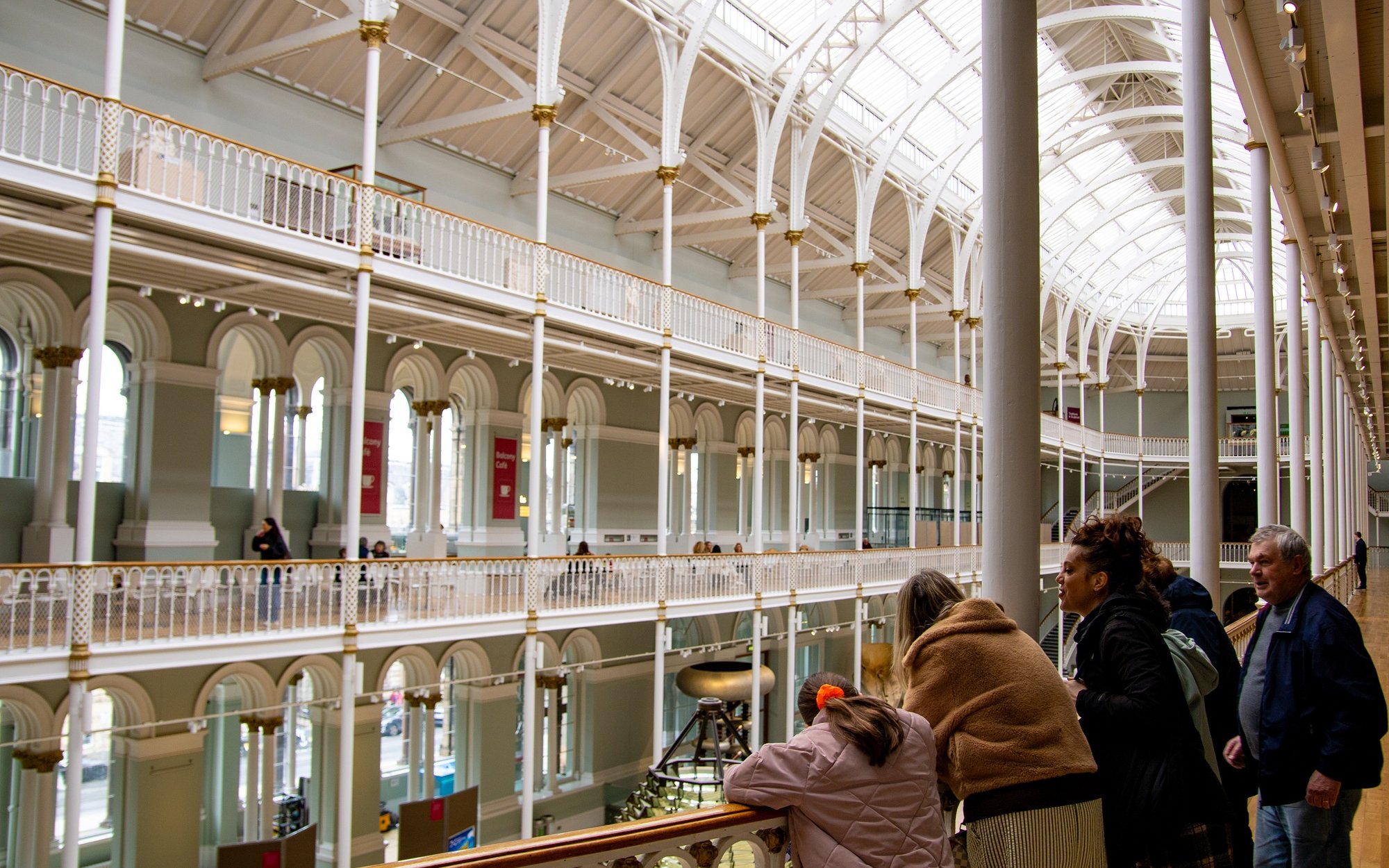 Visitors exploring the interior of the National Museum of Scotland in Edinburgh.