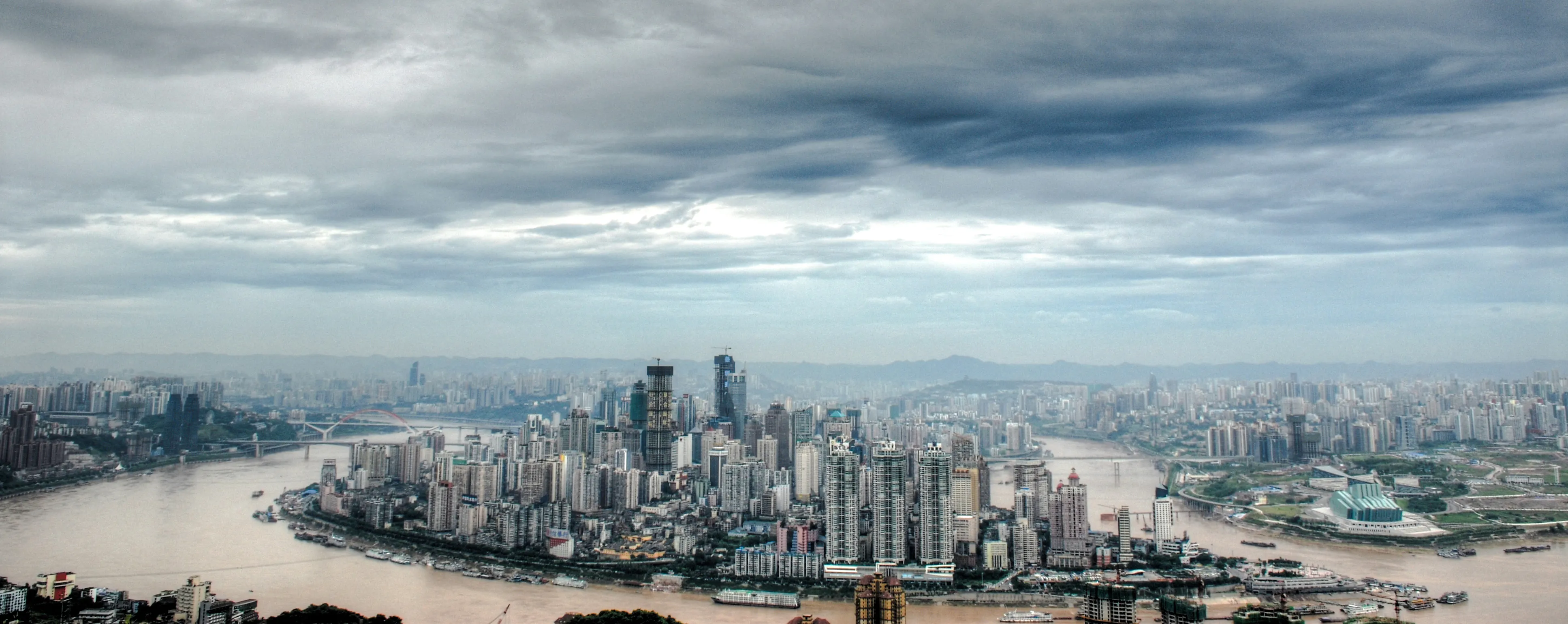 Chongqing skyline with Yangtze River and high-rise buildings, view from a private car tour.