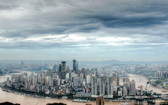 Chongqing skyline with Yangtze River and high-rise buildings, view from a private car tour.