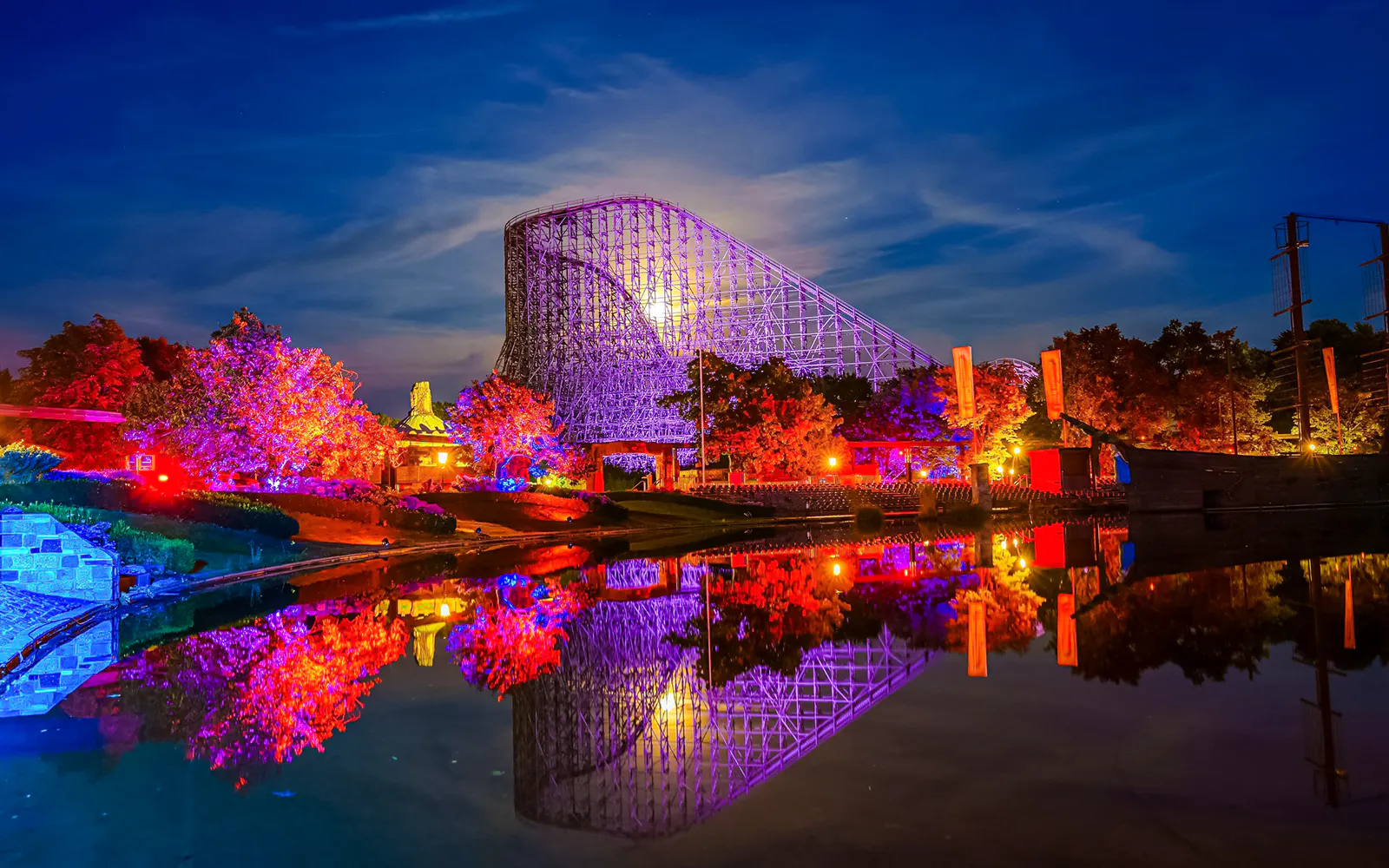 Roller coaster illuminated at night during Halloween at Heide Park.
