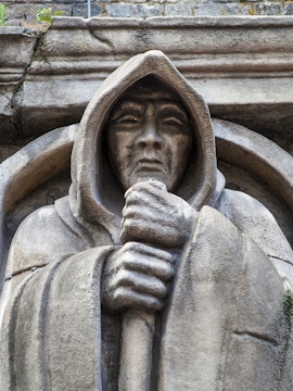 Stone statue of a hooded figure at London Dungeon, London.