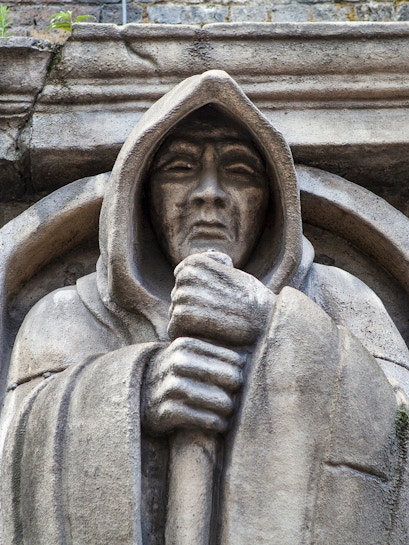 Stone statue of a hooded figure at London Dungeon, London.