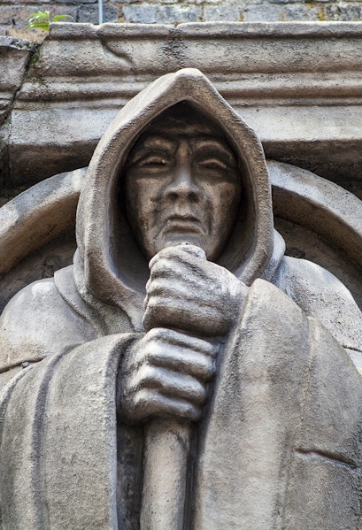 Stone statue of a hooded figure at London Dungeon, London.