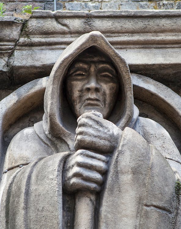 Stone statue of a hooded figure at London Dungeon, London.