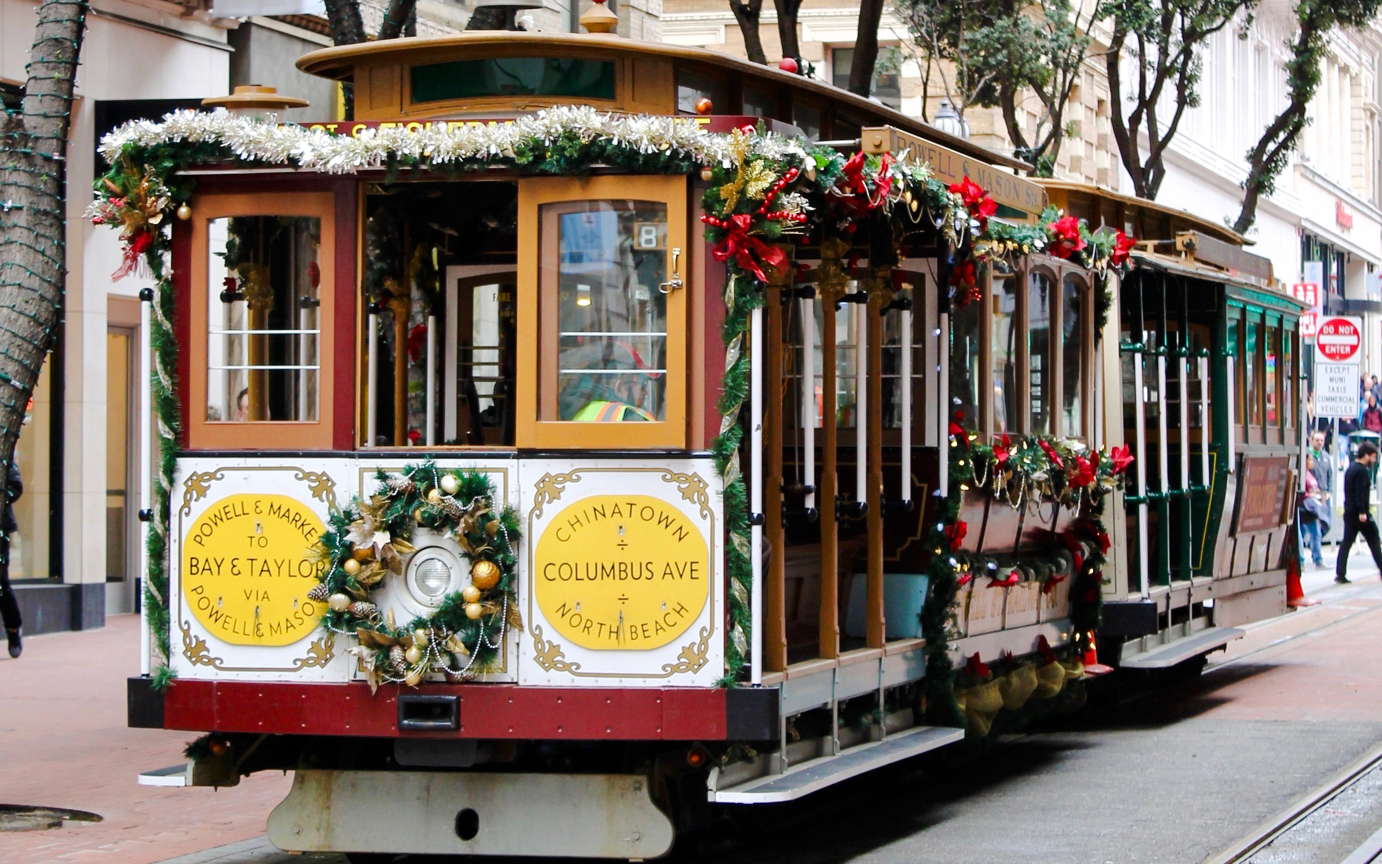 San Francisco holiday streetcar decorated with festive garlands on Powell Street.