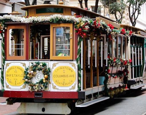 San Francisco holiday streetcar decorated with festive garlands on Powell Street.
