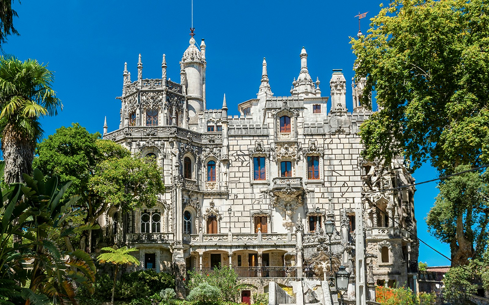Quinta da Regaleira palace and gardens in Sintra, Portugal, showcasing Gothic architecture.