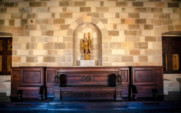 Wooden bench and statue inside Palace of the Grand Master of the Knights of Rhodes.