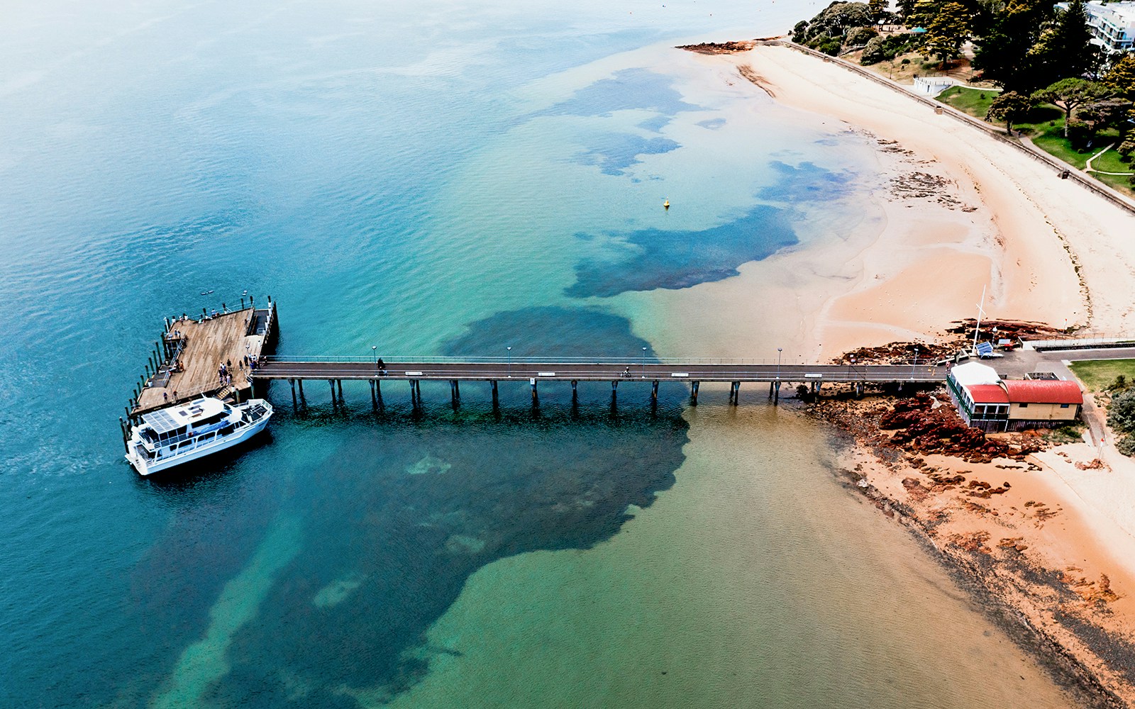 Phillip Island pier with cruise boat docked for seal watching tour.