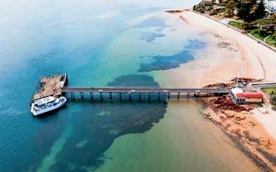 Phillip Island pier with cruise boat docked for seal watching tour.
