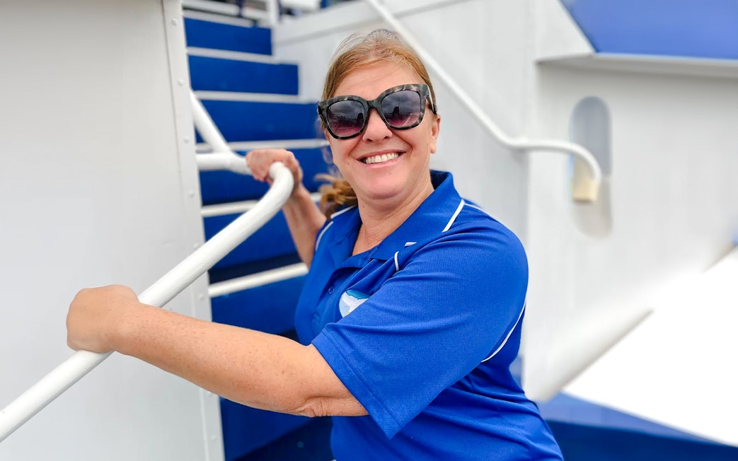 Guide smiling on a whale watching cruise with Spirit of Gold Coast.