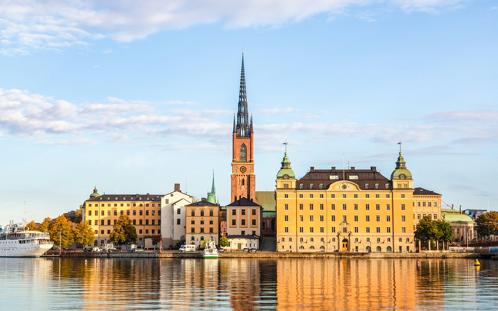 Djurgrden City Canal Cruise view of Gamla Stan, Stockholm's old town, with historic buildings and spire.