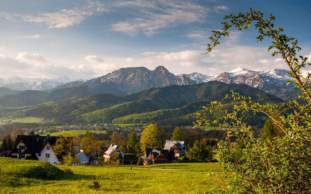 Zakopane mountains with village houses in the foreground, Poland.