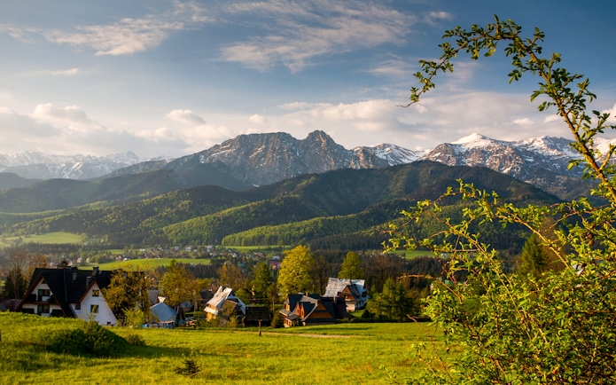Zakopane mountains with village houses in the foreground, Poland.