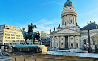 Statue and French Cathedral at Gendarmenmarkt, Berlin during Christmas treasure hunt.