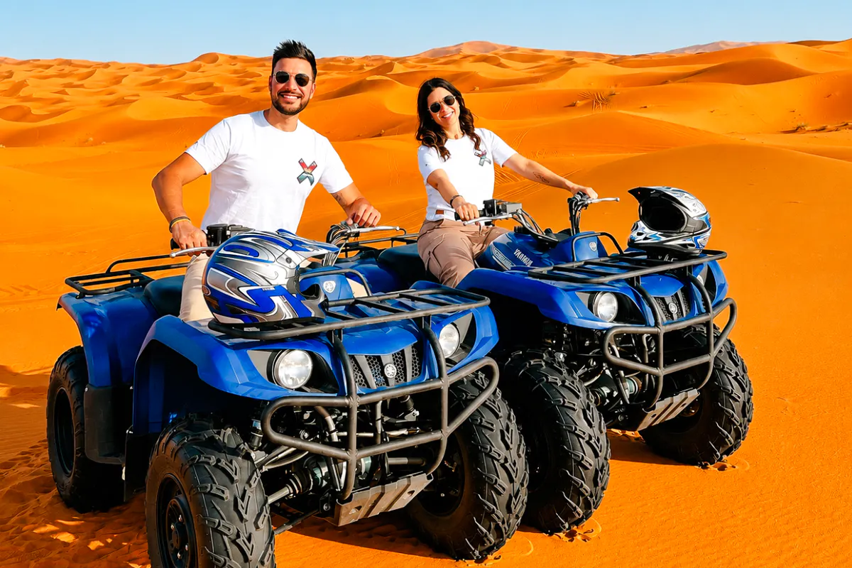 ATV riders in Abu Dhabi desert during safari tour.