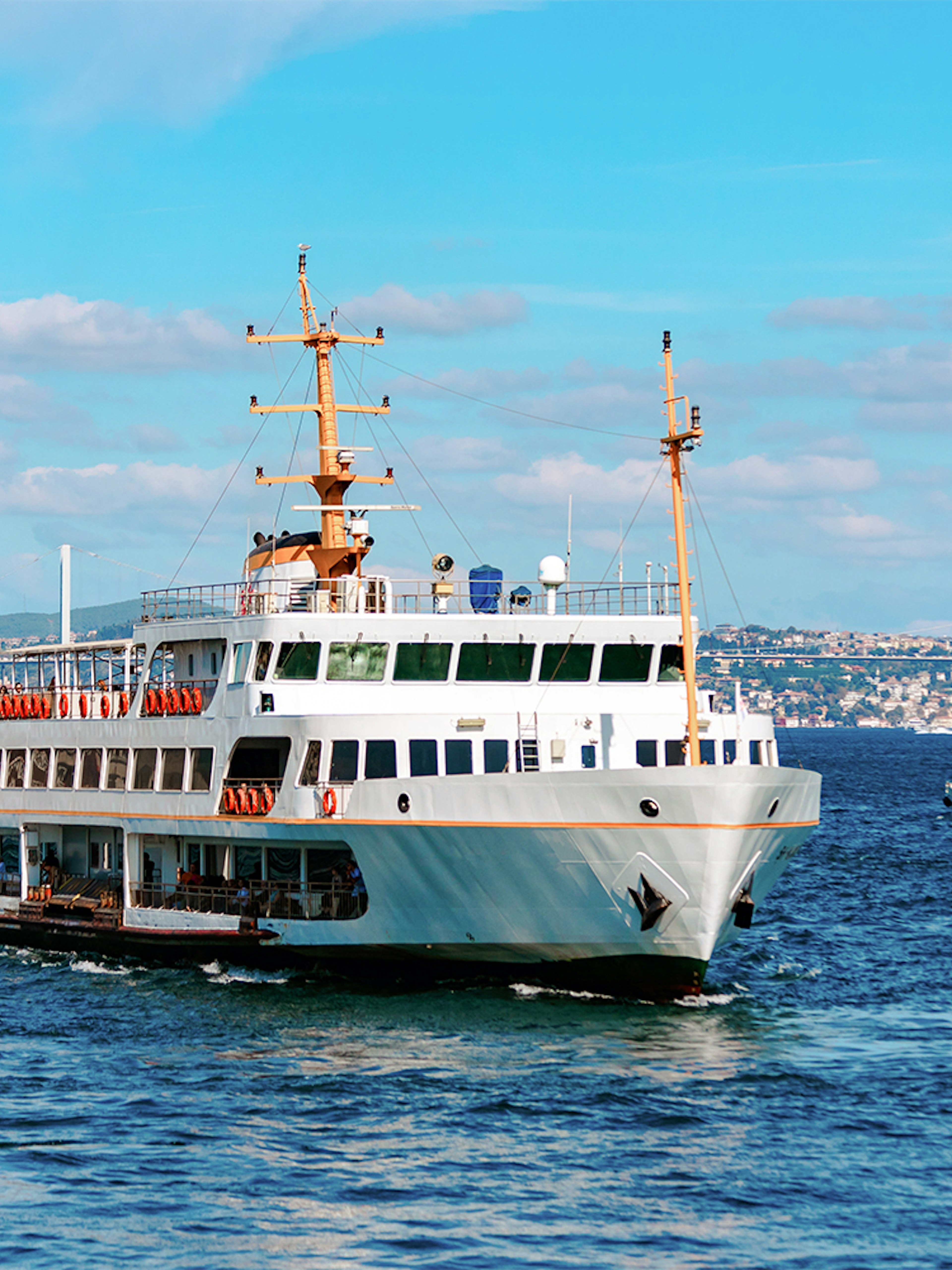 Ferry on the Bosphorus with Istanbul skyline in the background.