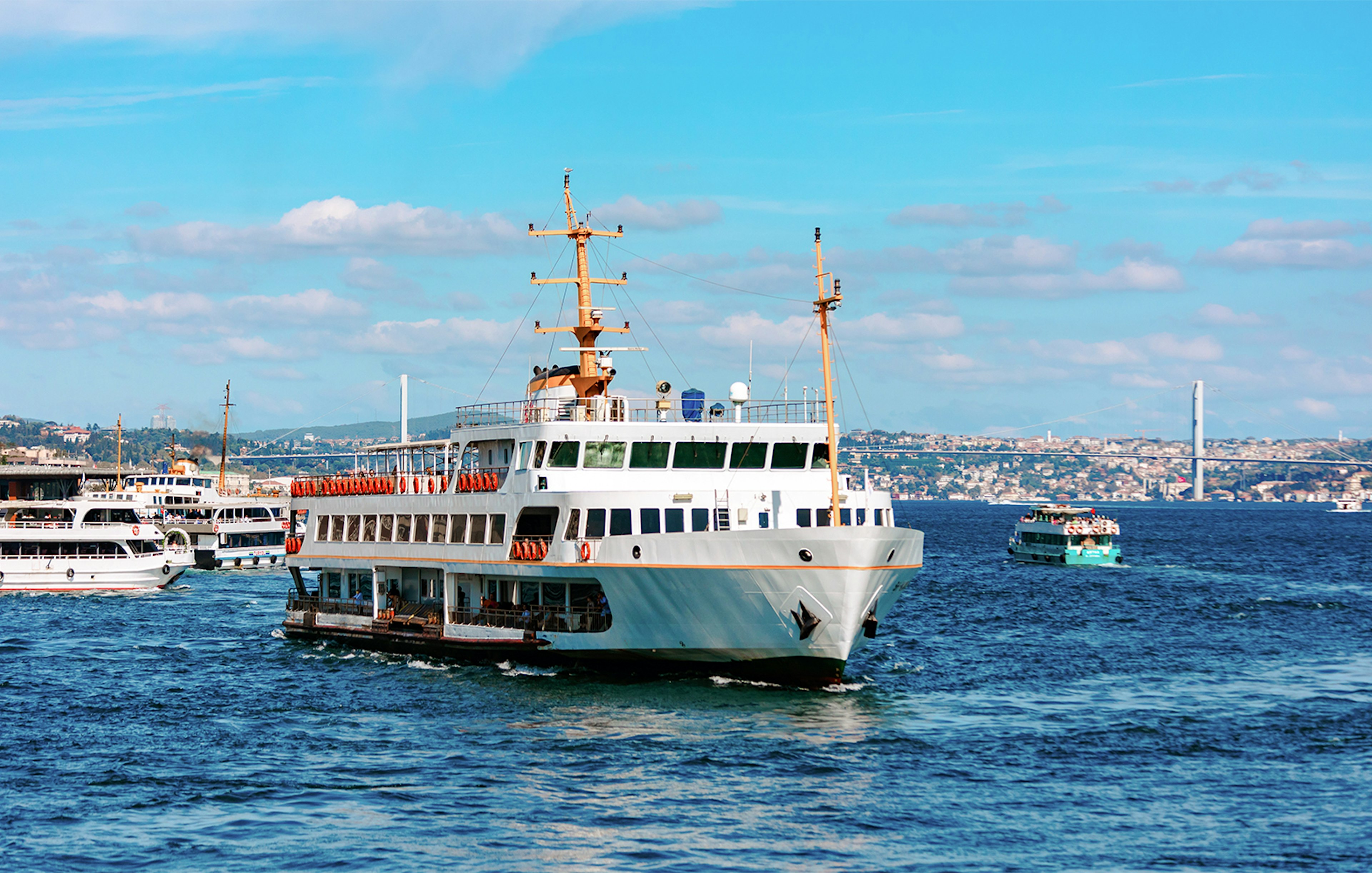 Ferry on the Bosphorus with Istanbul skyline in the background.