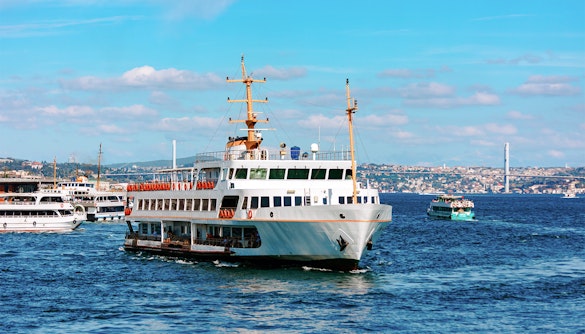 Ferry on the Bosphorus with Istanbul skyline in the background.
