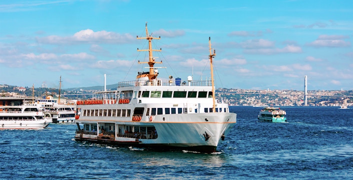 Ferry crossing the Bosphorus with Istanbul skyline in the background.