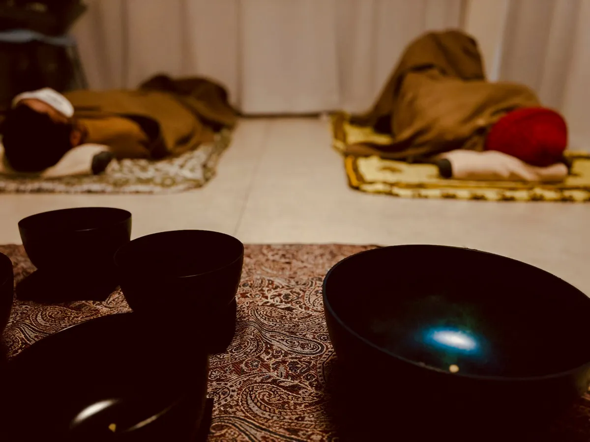 Private sound bath with lying-down meditation in Kyoto, featuring singing bowls and relaxation mats.