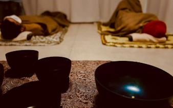 Private sound bath with lying-down meditation in Kyoto, featuring singing bowls and relaxation mats.