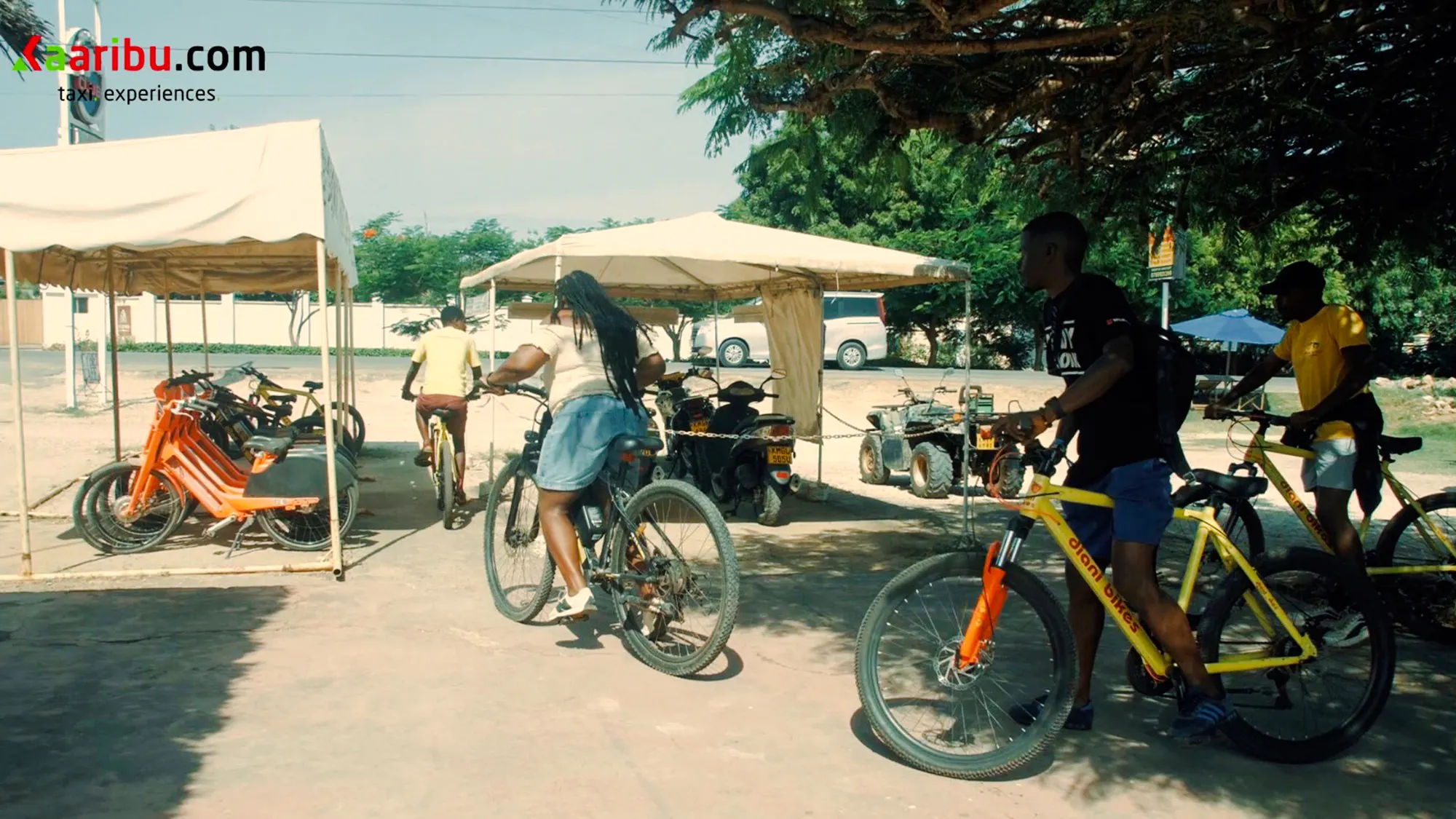 Cyclists starting a village tour on bikes at Diani Beach with hotel pick-up.