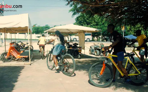 Cyclists starting a village tour on bikes at Diani Beach with hotel pick-up.