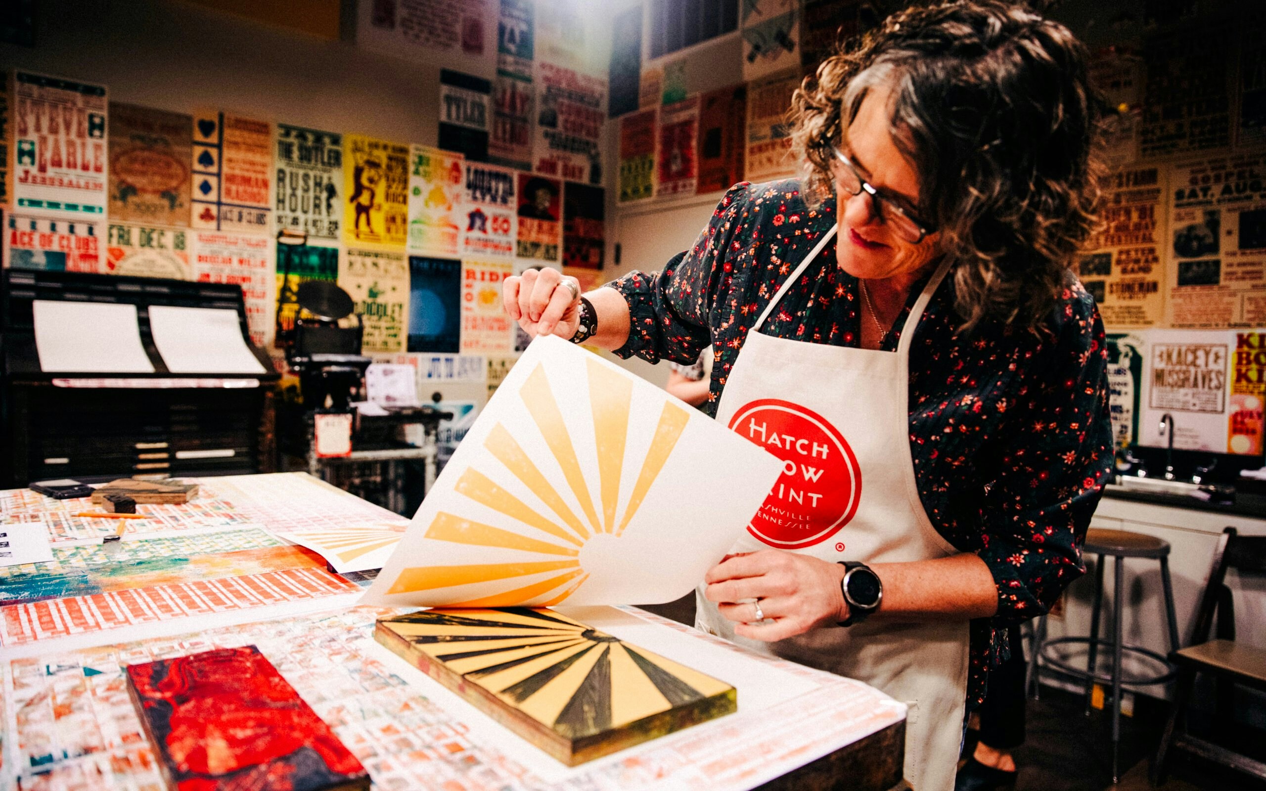 Person working on a letterpress print at Hatch Show Print shop, Nashville.