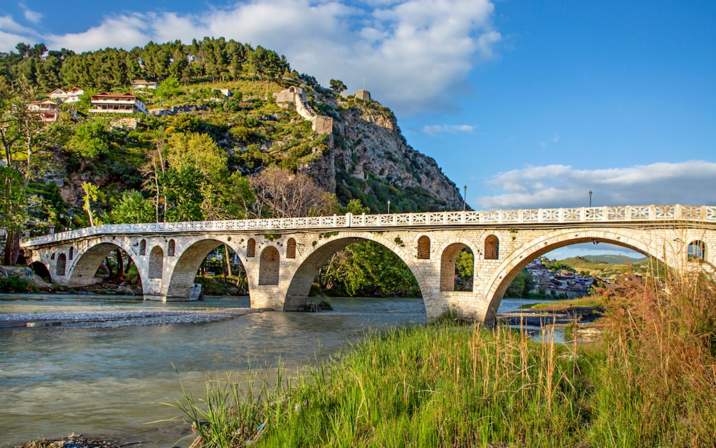 Historical arched bridge spanning the Osumi River in Berat, Albania.