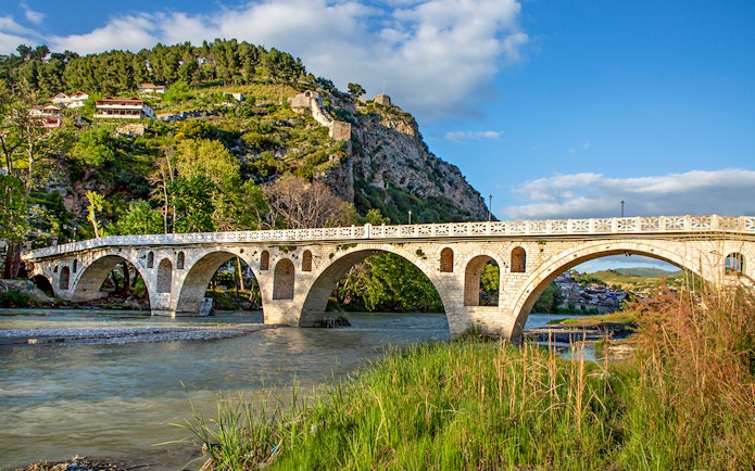 Historical arched bridge spanning the Osumi River in Berat, Albania.
