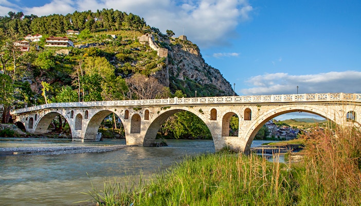 Historical arched bridge spanning the Osumi River in Berat, Albania.