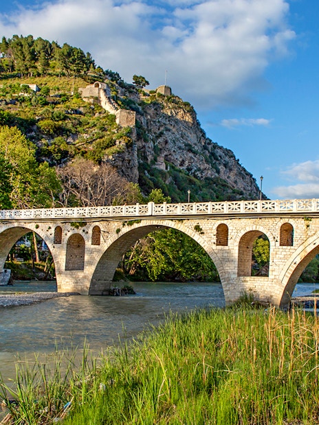 Historical arched bridge spanning the Osumi River in Berat, Albania.